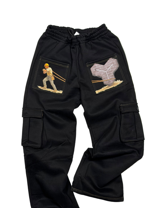 Black cargo pants with embroidered designs on a white background
