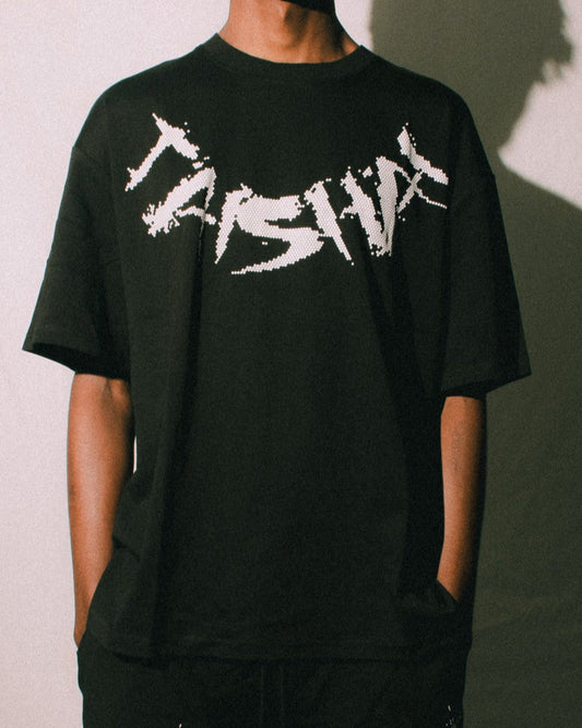 Person wearing a black t-shirt and shorts with white text against a white background